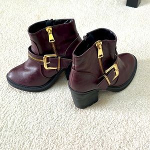 Burgundy/Purple boots. Gold buckle and zipper. Womens size 8.5
